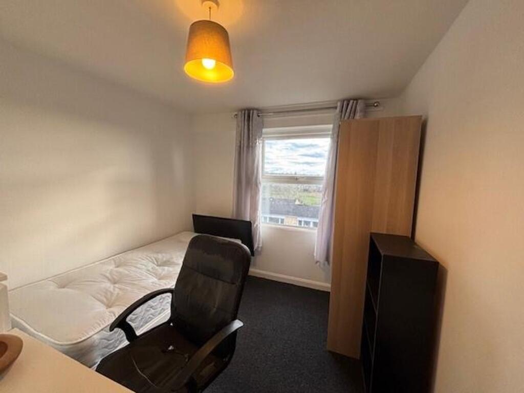 This inviting double bedroom features a large w...