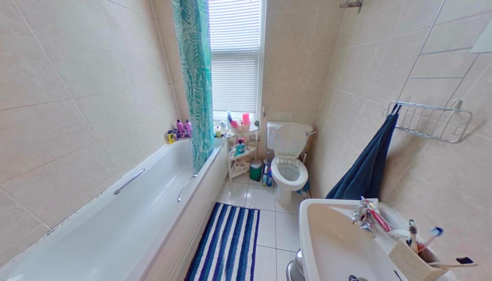 Bright and clean bathroom featuring a full-size...