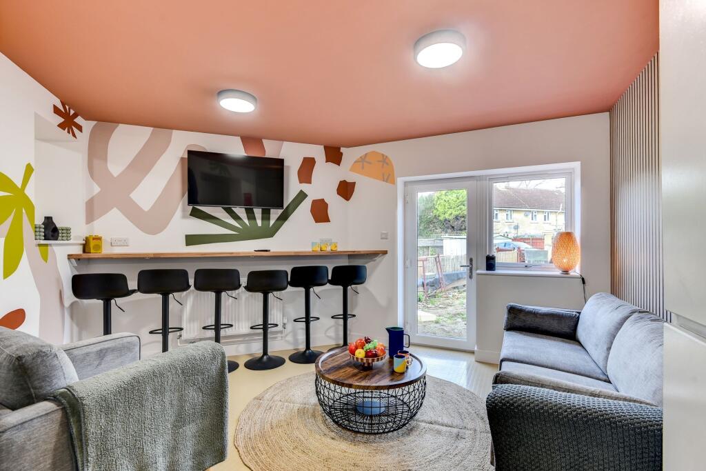 This vibrant communal lounge features modern de...