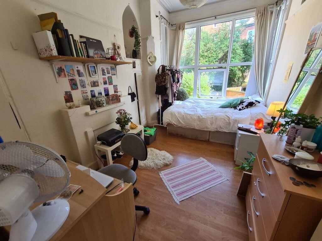 Bright and cozy bedroom featuring a large windo...