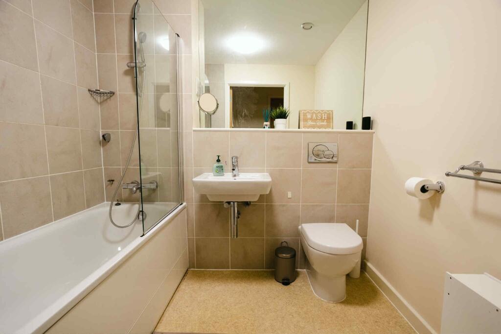 A modern and clean bathroom suite featuring a s...
