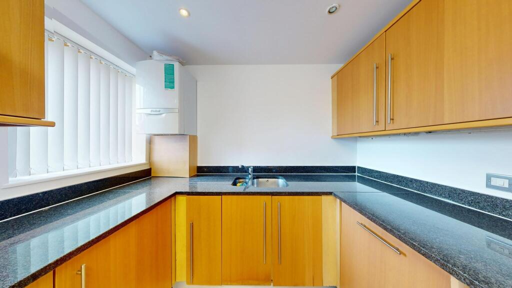 Bright and modern kitchen with ample countertop...