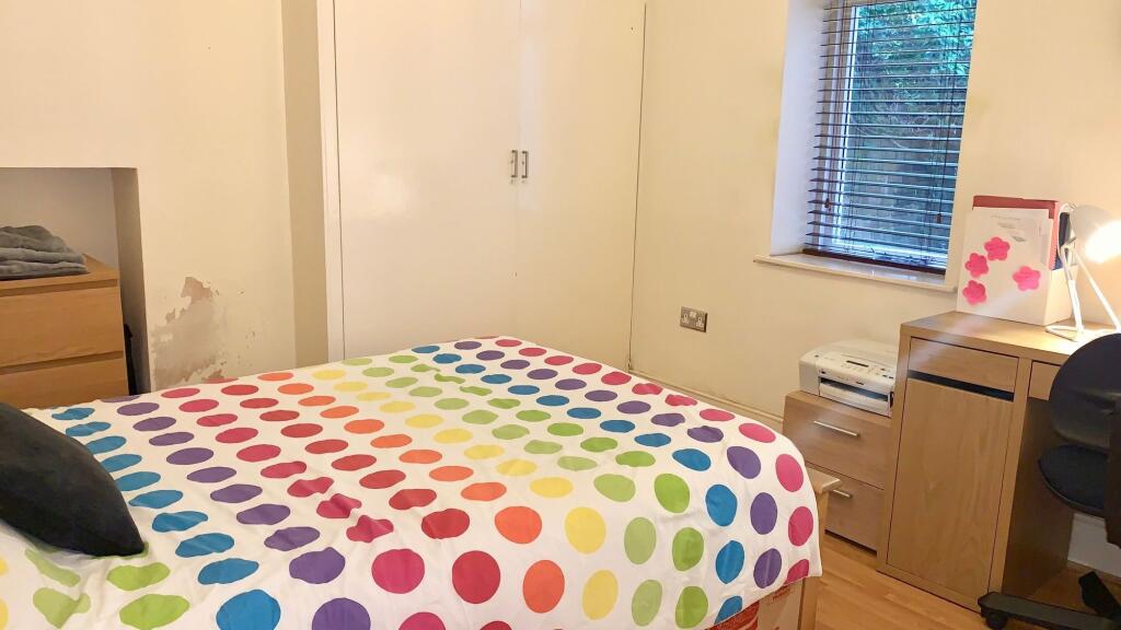 Bright and cozy double bedroom featuring a colo...