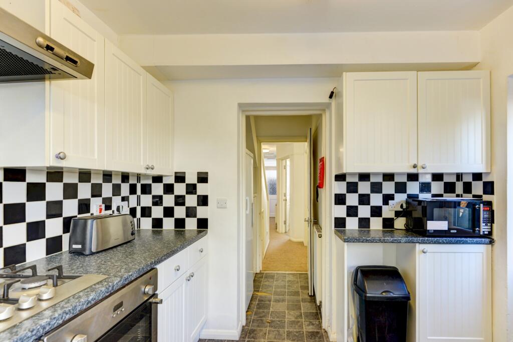 Bright and tidy kitchen featuring modern applia...