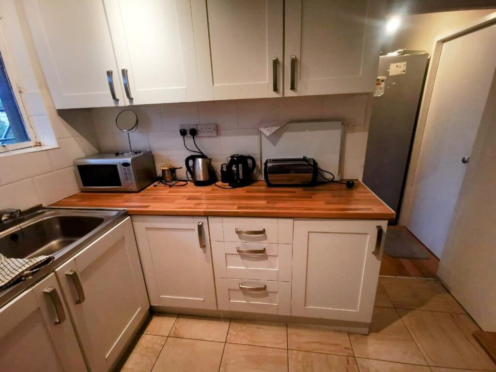 A functional kitchenette with modern appliances...