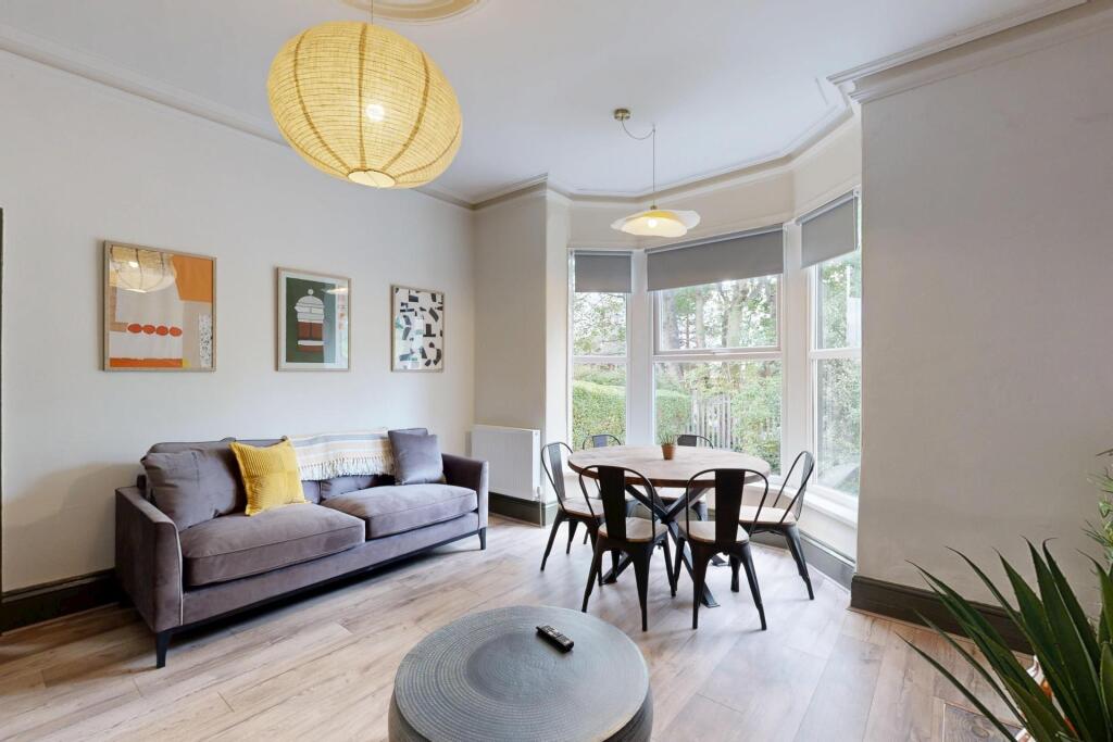 A bright and stylish living room featuring a la...