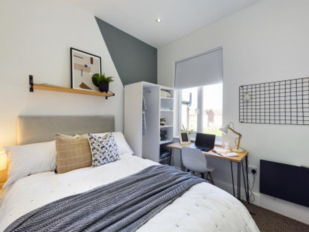 A bright and inviting double bedroom featuring ...