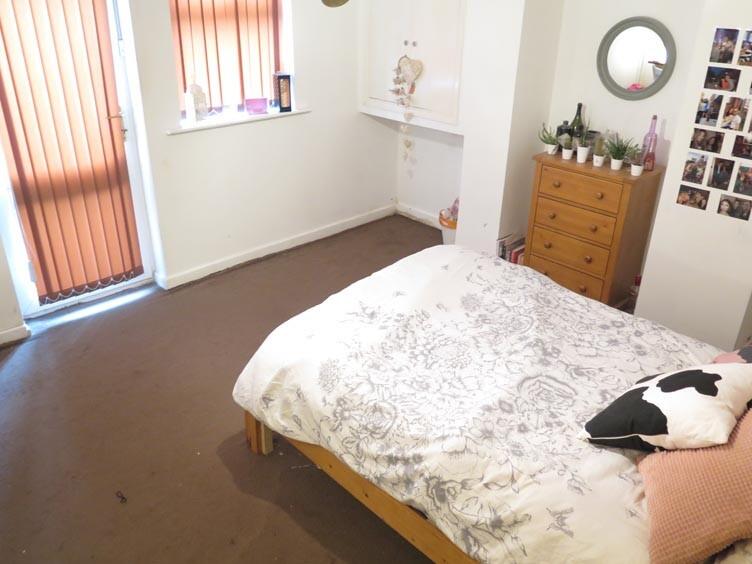 A cozy bedroom featuring a double bed with a st...