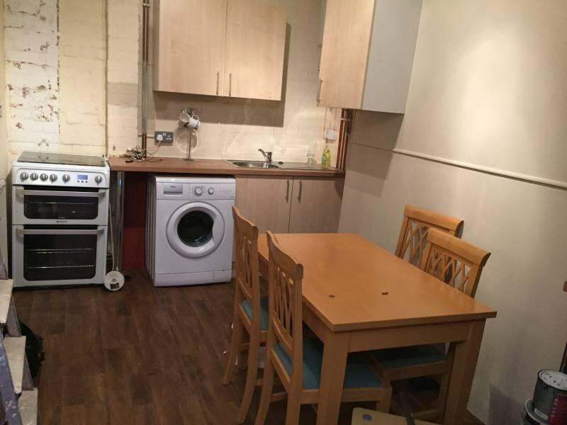A compact kitchen area with essential appliance...