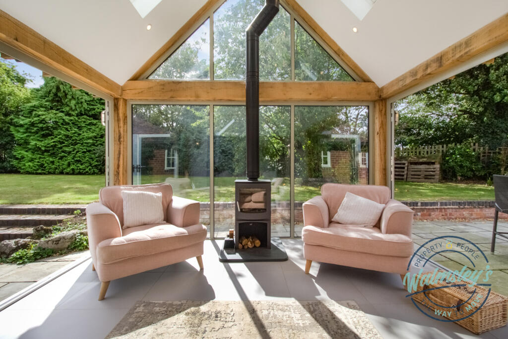 Log burner within wooden framed extension