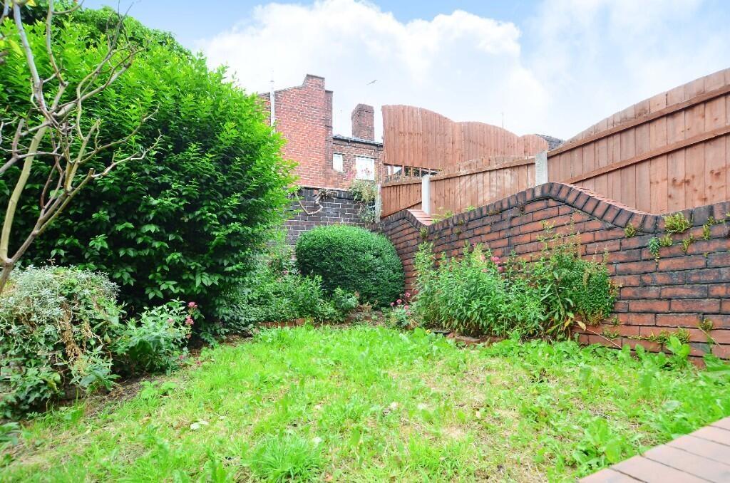 A bright and well-maintained garden featuring l...