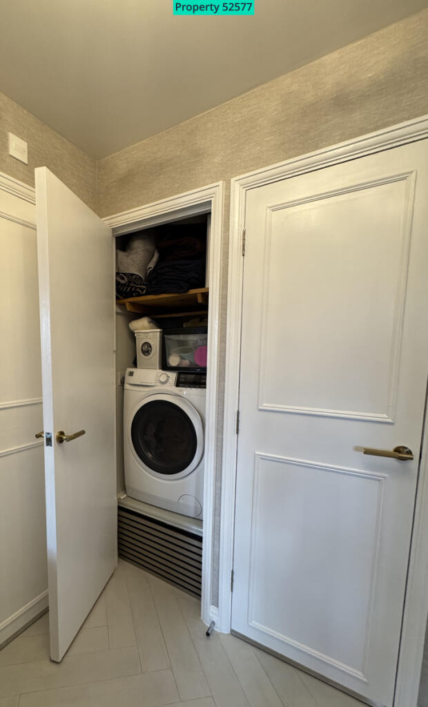 Hallway storage cupboard housing washer/dryer