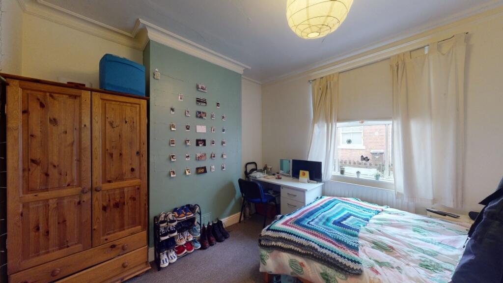 Cozy and well-lit single bedroom featuring a co...