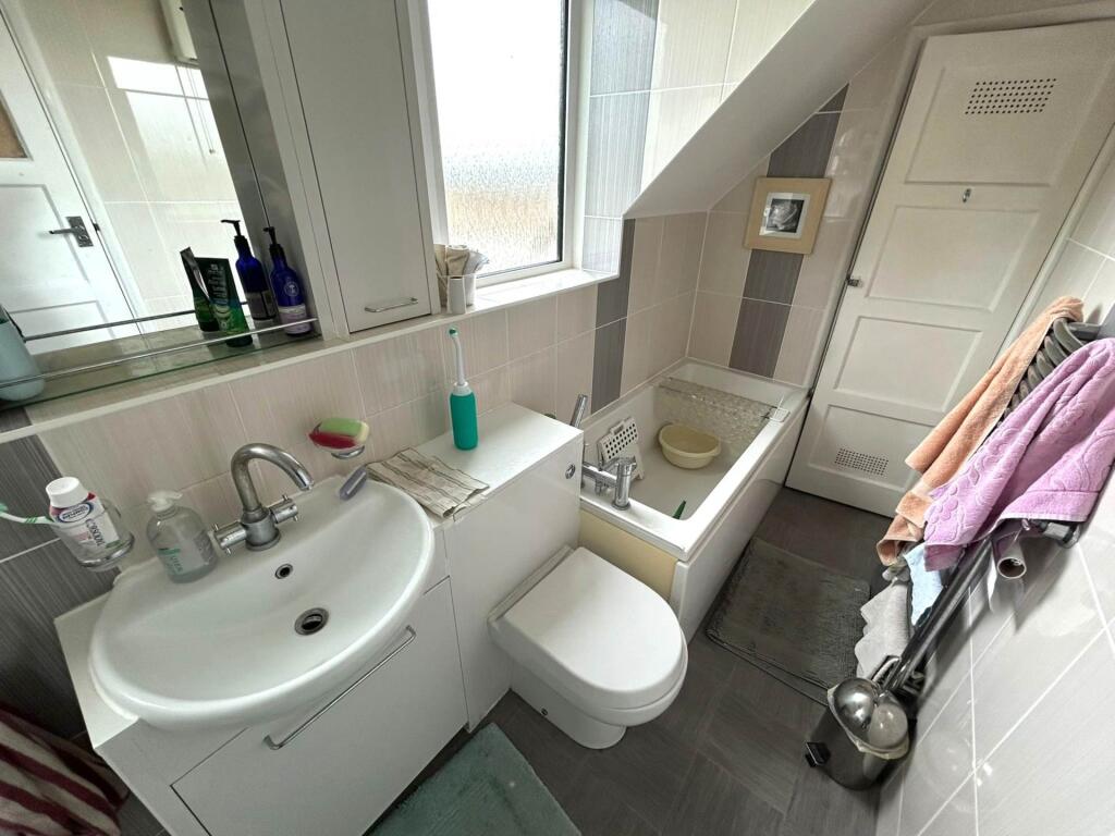 Bright compact bathroom with a modern sink and ...