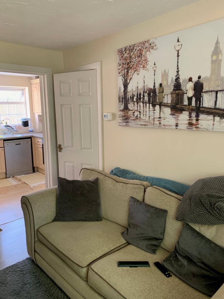 A cozy living room with a comfortable sofa, per...