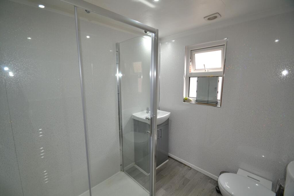 Bright and modern bathroom featuring a spacious...