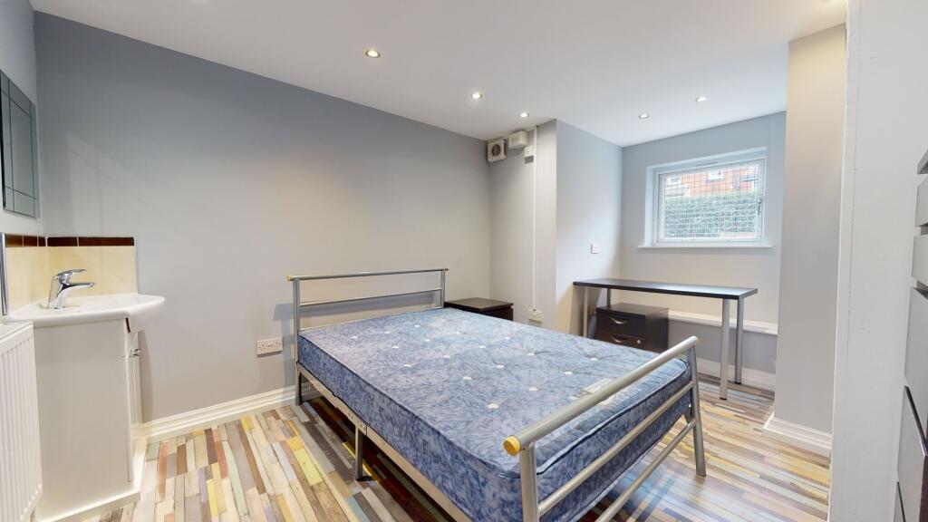 Bright and tidy bedroom featuring a comfortable...