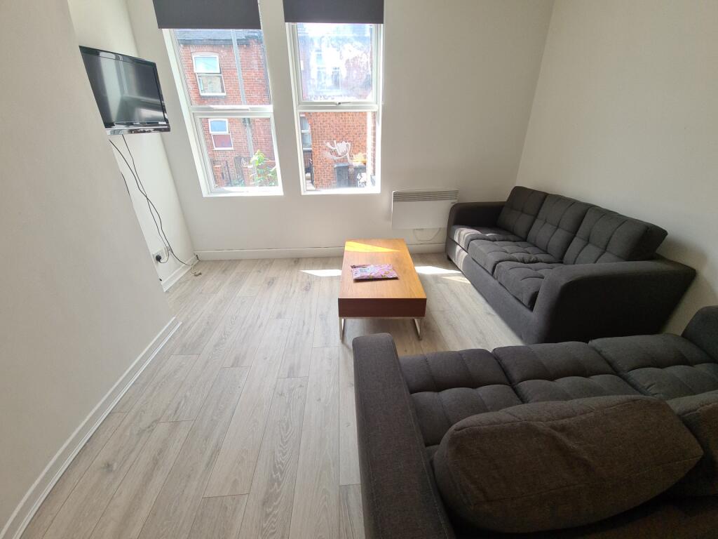 A bright and inviting living room featuring two...