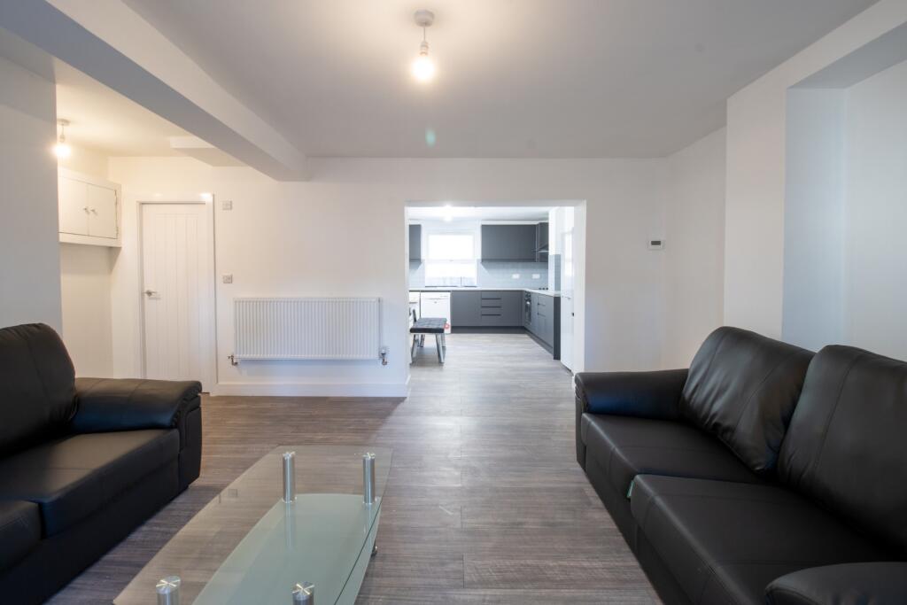 A bright and modern living room featuring comfo...