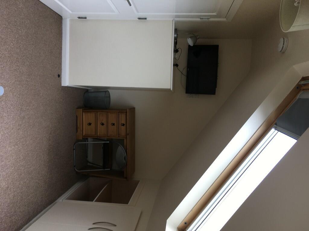 A clean and tidy small toilet room with a neutr...