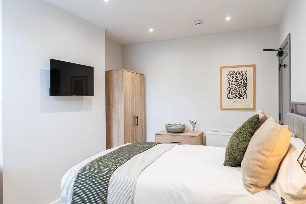 A bright and spacious master bedroom featuring ...