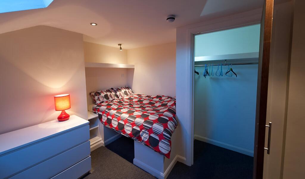 Cozy double bedroom featuring a comfortable bed...