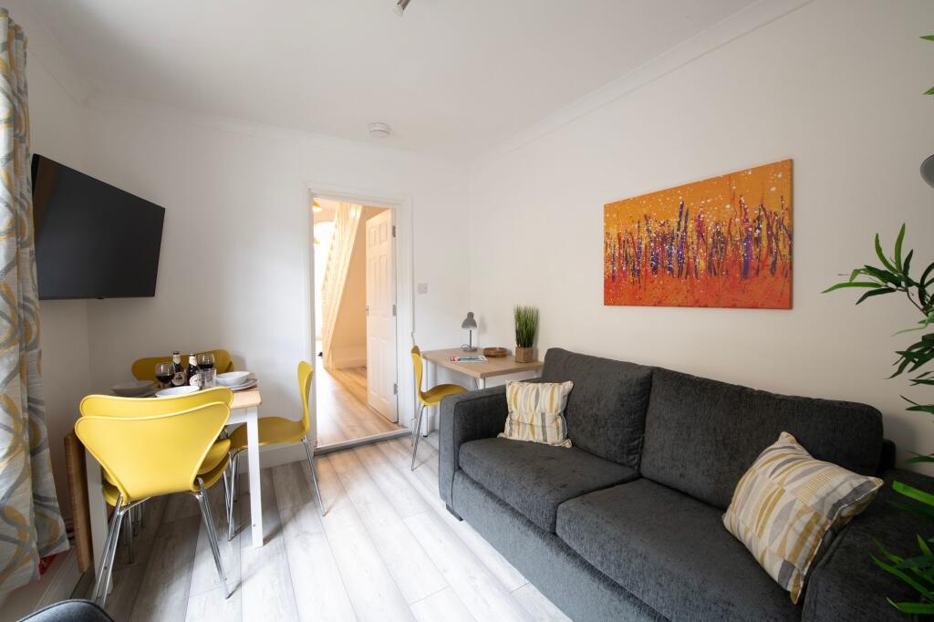 Bright and welcoming living room featuring mode...