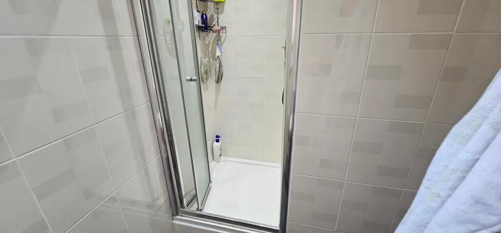 This well-maintained bathroom features a modern...