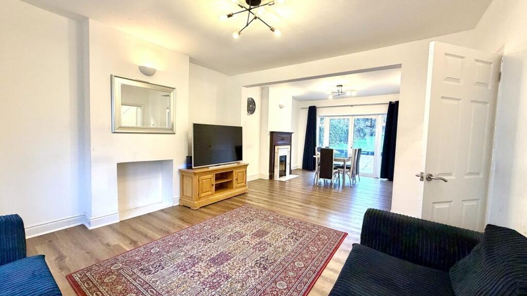 Bright, open-plan living area with wooden floor...