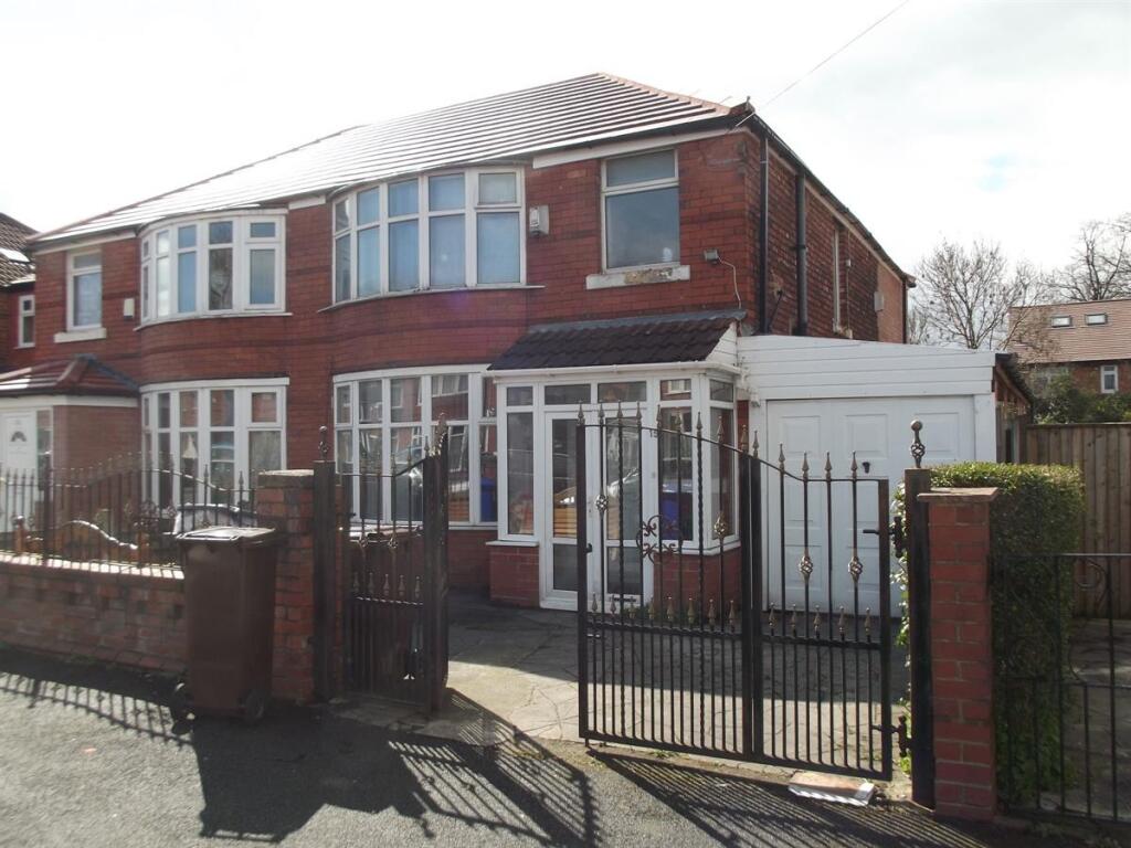 Red-brick semi-detached house with gated front ...