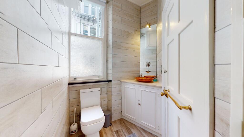 A well-maintained and bright single toilet room...