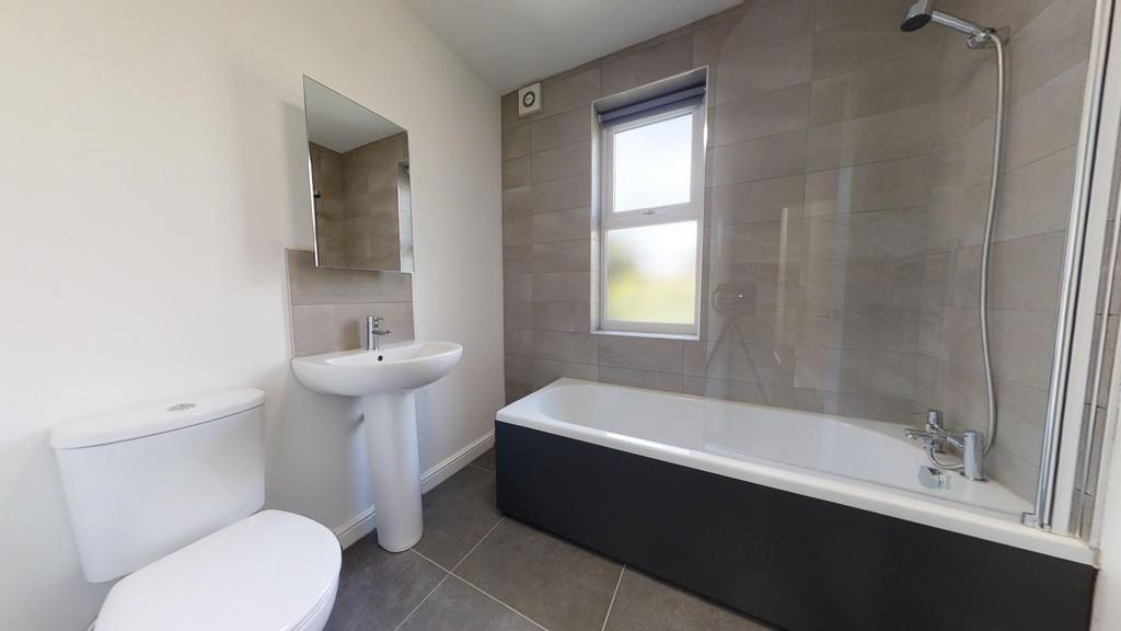 Bright and modern bathroom featuring a full bat...