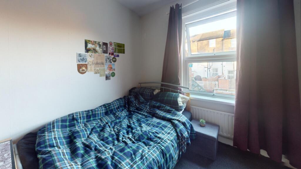 A cozy double bedroom with good natural light a...