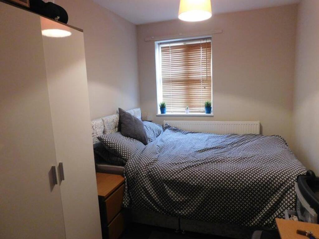 A cozy and inviting double bedroom with ample n...