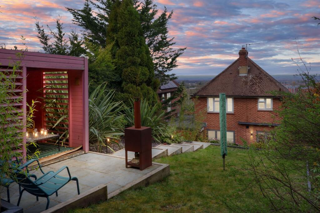 Rear view of the property at dusk