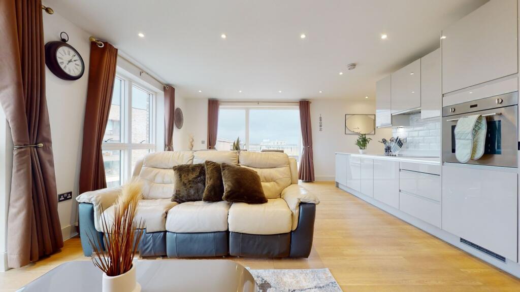 A modern and spacious living room with large wi...