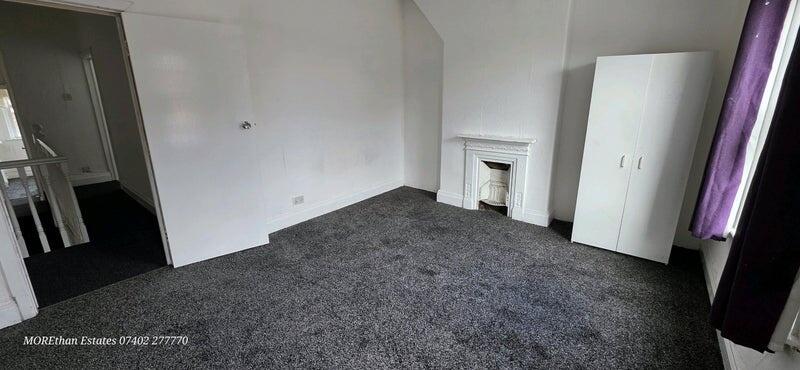 A well-lit double bedroom featuring a neutral c...