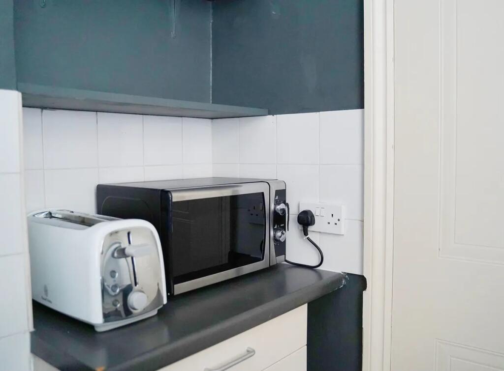 A tidy kitchen corner featuring a sleek black m...