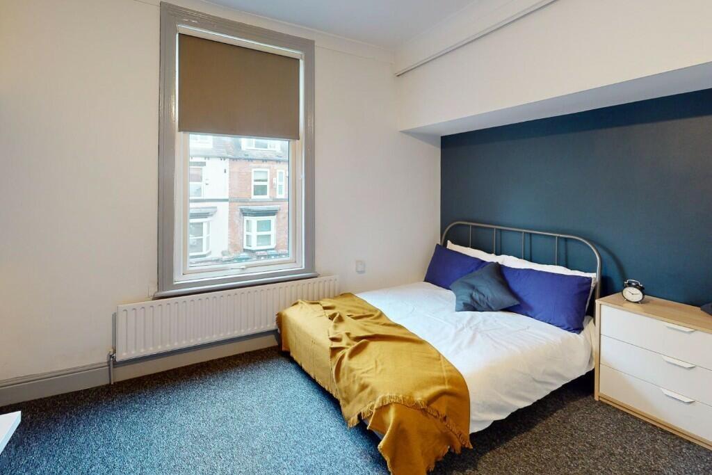 Bright and cozy double bedroom featuring a comf...