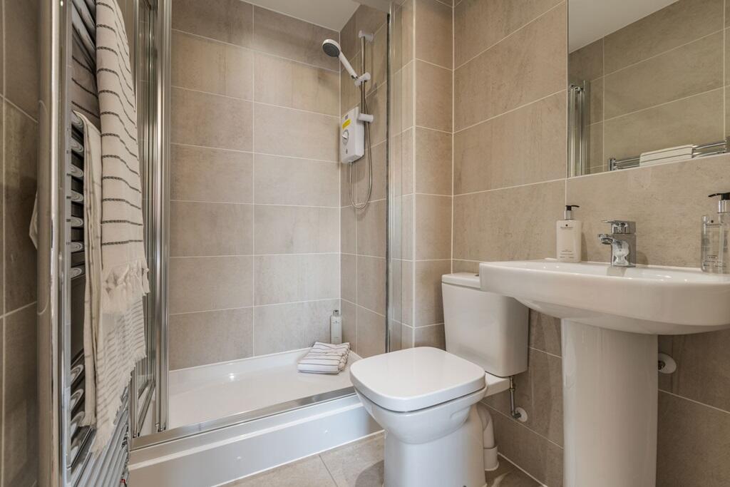 En suite with full width shower enclosure