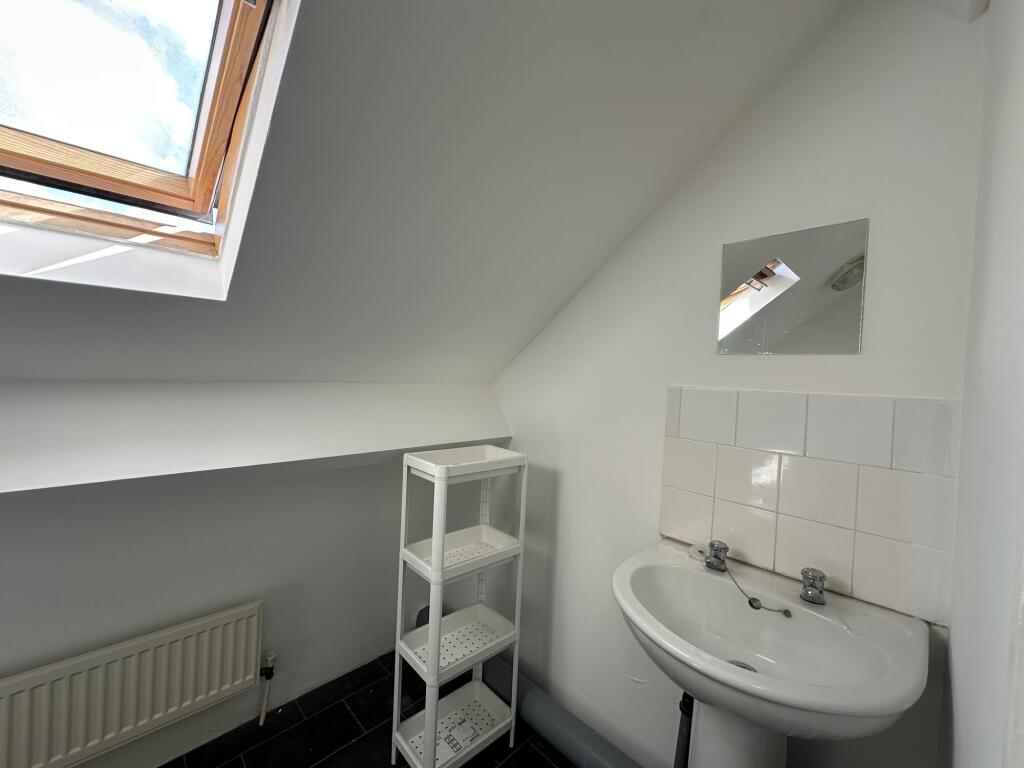 A clean, modern bathroom featuring a white sink...