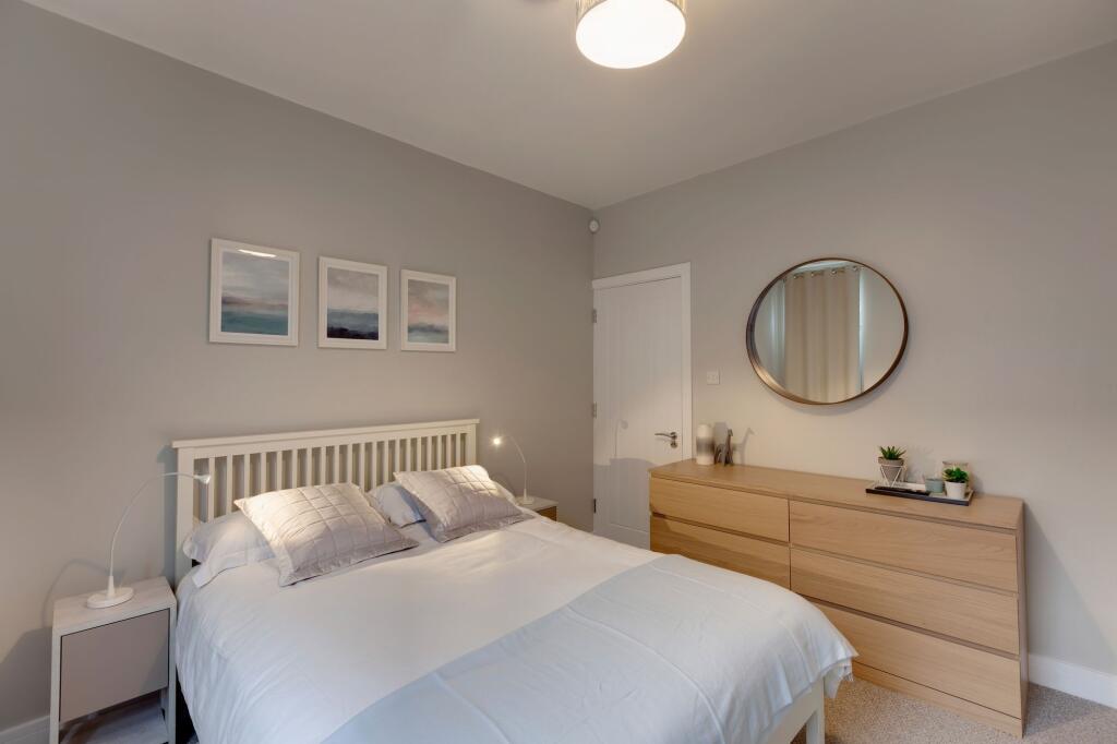 Bright and inviting master bedroom featuring a ...