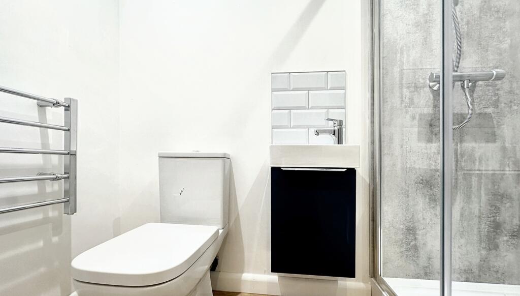 A modern bathroom featuring a sleek shower and ...