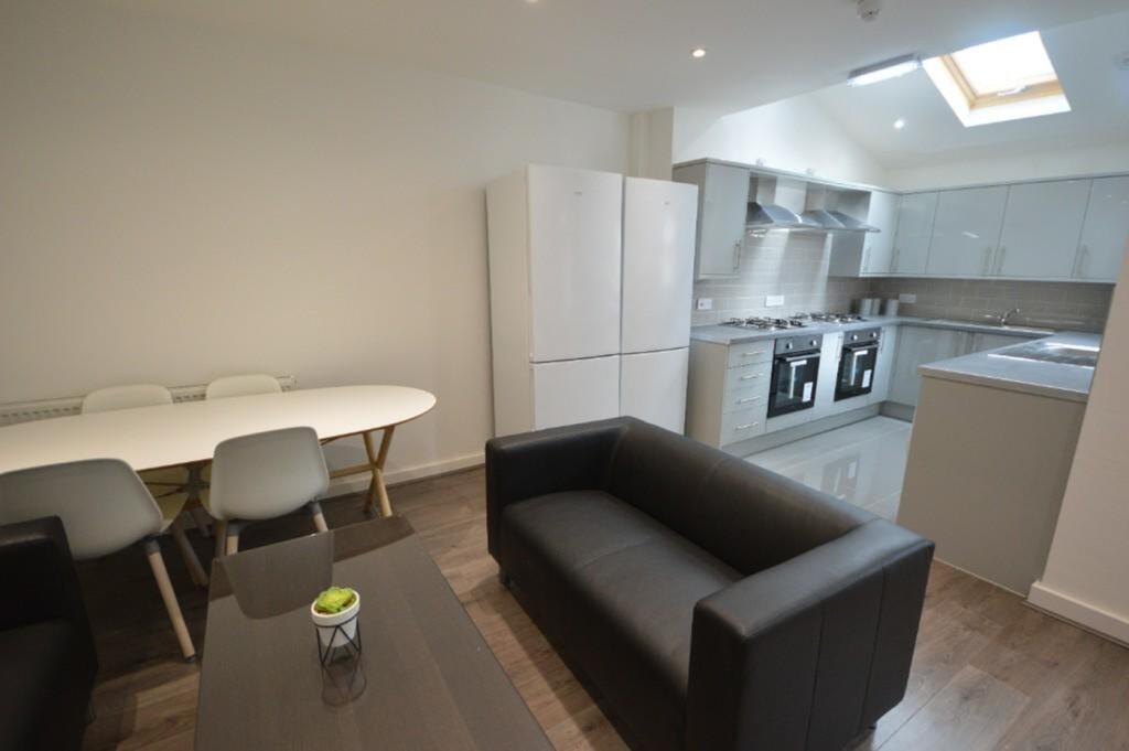 Modern kitchen featuring sleek cabinetry, ample...