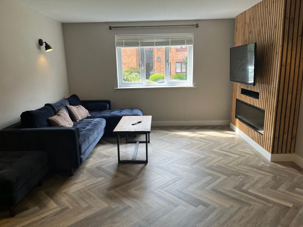 A modern and tidy living room featuring a styli...