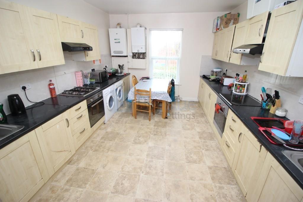 Bright and spacious kitchen with ample cabinetr...