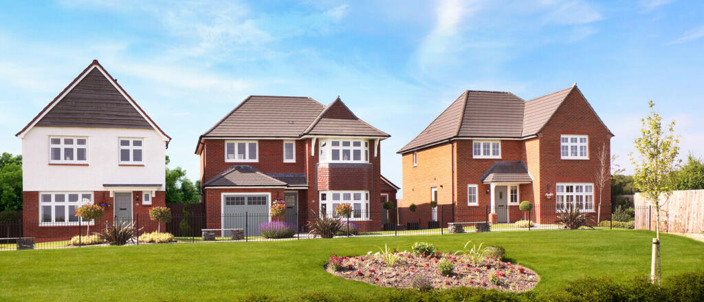 Three modern detached houses with well-maintained front gardens and a colourful flowerbed under a bl