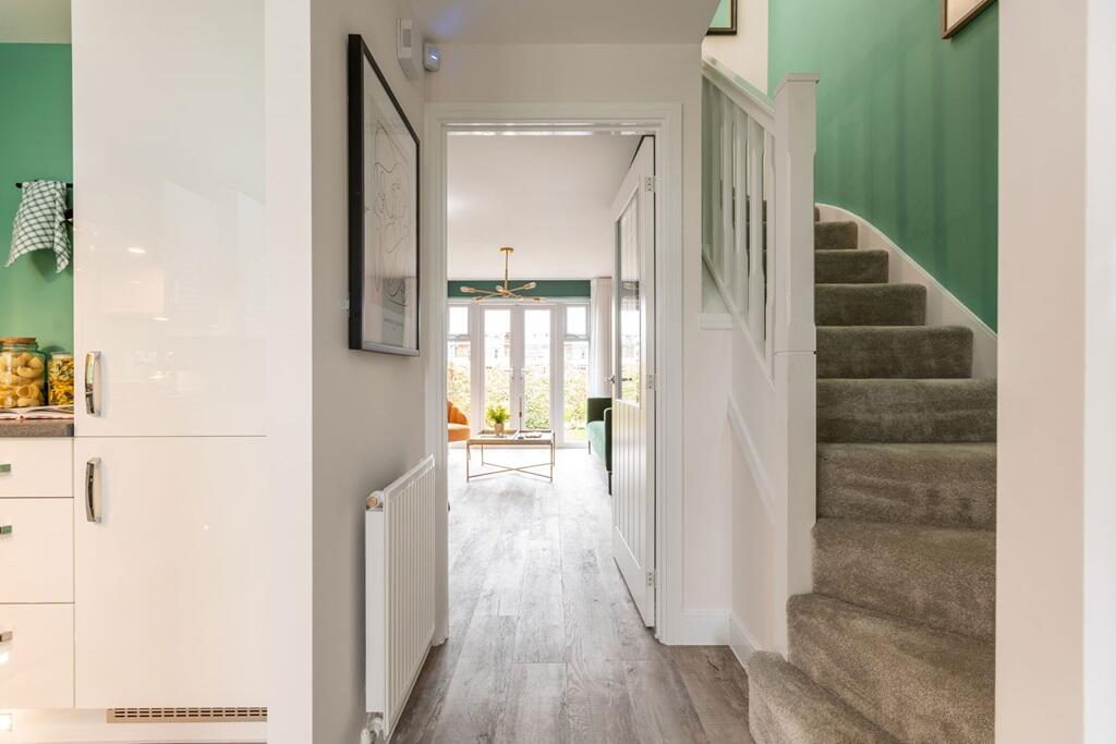 A welcoming hallway opens out to the kitchen and living space