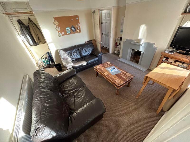 A cozy living room featuring two black leather ...