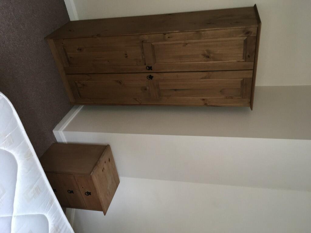 A neatly arranged double bedroom featuring a si...